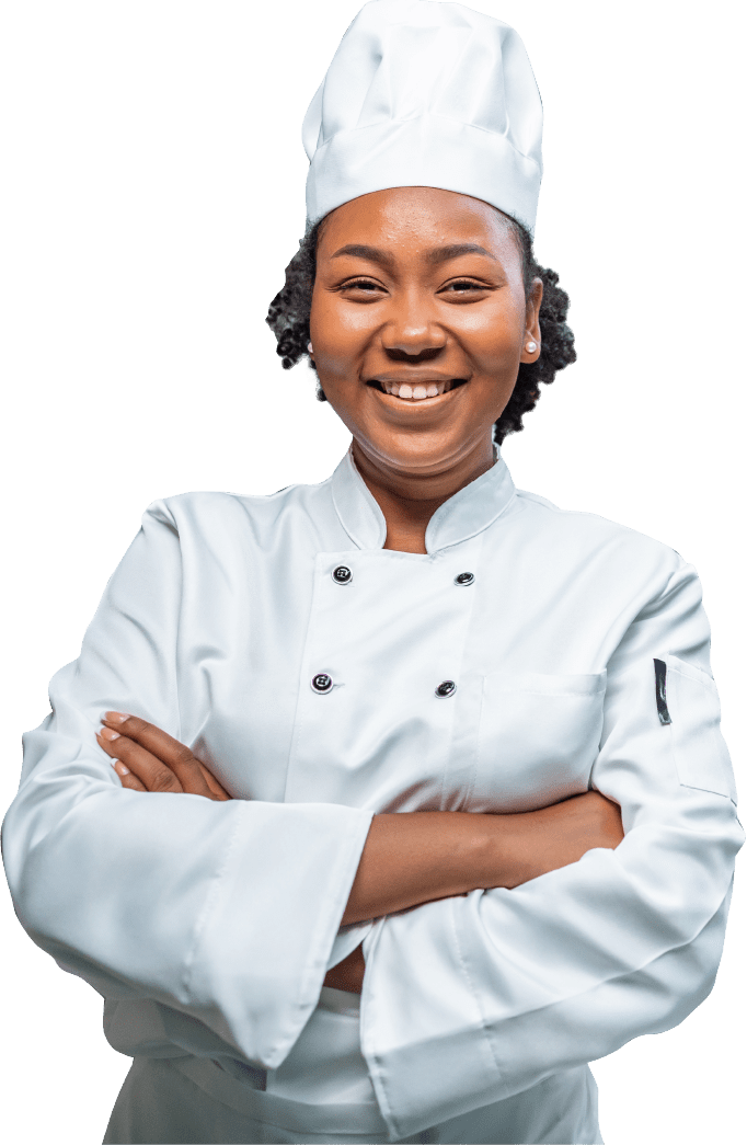 A smiling chef in a white uniform and chefs hat stands with arms crossed, looking confident and approachable, against a transparent background.