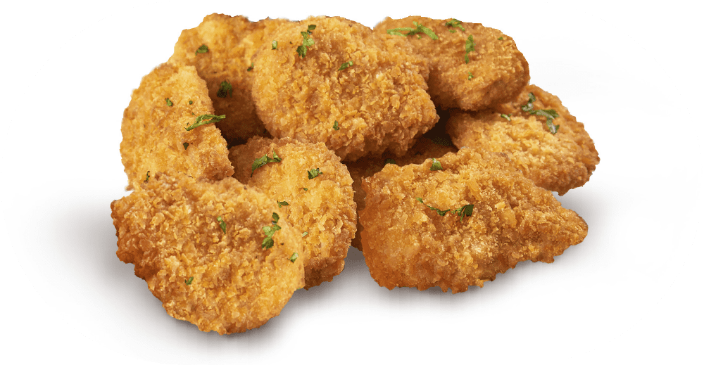 Country Range - A pile of crispy, golden-brown breaded chicken nuggets garnished with small green herbs, arranged on a white surface.
